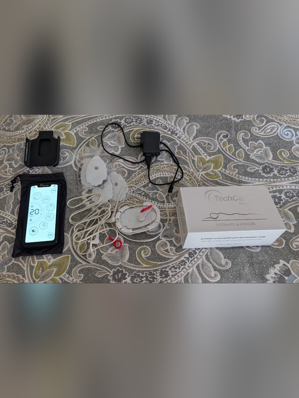 TENS Unit Muscle Stimulator with White Electrodes and Black Controller